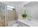Well-lit bathroom with a tub-shower, neutral tile, and a vanity with a white countertop at 14281 Heritage Landing Blvd # 1418, Punta Gorda, FL 33955