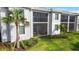Exterior of a multi-story home with screened lanais and lush landscaping at 14281 Heritage Landing Blvd # 1418, Punta Gorda, FL 33955