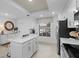Modern kitchen featuring white cabinets, stainless steel appliances, and a cozy breakfast nook with a view at 14281 Heritage Landing Blvd # 1418, Punta Gorda, FL 33955