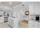 Open-concept kitchen with white cabinets, an island, and a charming breakfast nook, creating a bright and airy space at 14281 Heritage Landing Blvd # 1418, Punta Gorda, FL 33955