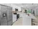 Open kitchen featuring stainless steel appliances and a breakfast bar that overlooks the living area at 14281 Heritage Landing Blvd # 1418, Punta Gorda, FL 33955