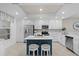 Stylish kitchen with white cabinetry, stainless steel appliances, and a blue island with seating at 14281 Heritage Landing Blvd # 1418, Punta Gorda, FL 33955