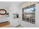 Bright kitchen nook featuring white cabinetry and a charming window overlooking the outdoor patio at 14281 Heritage Landing Blvd # 1418, Punta Gorda, FL 33955