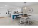 Open-concept layout showcasing the kitchen with white cabinets, stainless appliances, and an adjacent dining area at 14281 Heritage Landing Blvd # 1418, Punta Gorda, FL 33955
