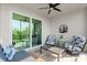Covered lanai with comfortable seating, ceiling fan, and views of the surrounding greenery at 14281 Heritage Landing Blvd # 1418, Punta Gorda, FL 33955