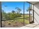 Tranquil lanai showcasing serene green space with lush tropical landscaping and blue skies at 14281 Heritage Landing Blvd # 1418, Punta Gorda, FL 33955