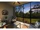 Inviting lanai with cozy seating overlooking a beautiful sunset and tropical landscaping at 14281 Heritage Landing Blvd # 1418, Punta Gorda, FL 33955
