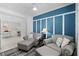 Charming living room with a blue accent wall, gray seating and view to the adjacent dining area at 14281 Heritage Landing Blvd # 1418, Punta Gorda, FL 33955