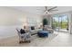 Inviting living room with comfortable seating, a ceiling fan, and sliding glass doors leading to an outdoor balcony at 14281 Heritage Landing Blvd # 1418, Punta Gorda, FL 33955
