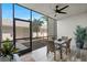 This screened patio features a ceiling fan, and wicker dining set with plants nearby at 14281 Heritage Landing Blvd # 1418, Punta Gorda, FL 33955