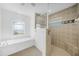 Bright bathroom showcasing a glass enclosed shower and a luxurious soaking tub at 15538 Aqua Cir, Port Charlotte, FL 33981