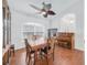 Dining room features tile flooring, large windows and an elegant ceiling fan at 15538 Aqua Cir, Port Charlotte, FL 33981