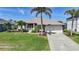 Charming single-story home with a well-manicured lawn, beautiful landscaping, and a two-car garage at 15538 Aqua Cir, Port Charlotte, FL 33981