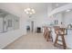 Open kitchen features pendant lighting, bar seating, and all-white cabinetry at 15538 Aqua Cir, Port Charlotte, FL 33981