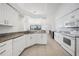 Bright kitchen features granite counters, white cabinets and modern appliances at 15538 Aqua Cir, Port Charlotte, FL 33981