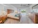 Main bedroom features wood furniture, an exterior view, and a ceiling fan at 15538 Aqua Cir, Port Charlotte, FL 33981