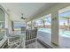 Inviting covered lanai with ceiling fan and waterfront view, perfect for outdoor dining at 15538 Aqua Cir, Port Charlotte, FL 33981