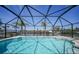 Screened-in pool overlooking the canal with serene water views and a spacious deck at 15538 Aqua Cir, Port Charlotte, FL 33981