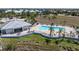 Aerial shot of a community pool with lounge area, clubhouse, and well-maintained landscaping at 2001 Bal Harbor Blvd # 2312, Punta Gorda, FL 33950