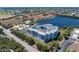 Aerial view of condo complex with lake views, community pool, parking, and tropical landscaping at 2001 Bal Harbor Blvd # 2312, Punta Gorda, FL 33950