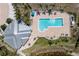 Aerial view of community pool with lounge seating, a clubhouse, and lush tropical landscaping at 2001 Bal Harbor Blvd # 2312, Punta Gorda, FL 33950
