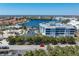 Aerial view of the building with pond, parking lot, and surrounding community with red roofs at 2001 Bal Harbor Blvd # 2312, Punta Gorda, FL 33950