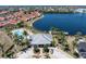 Aerial view of the community clubhouse and pool with mature landscaping and a picturesque lake at 2001 Bal Harbor Blvd # 2312, Punta Gorda, FL 33950