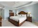 Spacious bedroom featuring a tray ceiling, wood furniture and neutral decor at 2001 Bal Harbor Blvd # 2312, Punta Gorda, FL 33950