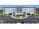 Exterior shot of building with manicured grounds and ample parking at 2001 Bal Harbor Blvd # 2312, Punta Gorda, FL 33950