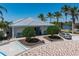 Clubhouse exterior featuring mature landscaping, brick paver entrance, and ample parking at 2001 Bal Harbor Blvd # 2312, Punta Gorda, FL 33950