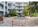 Beautiful courtyard featuring a fountain, lush greenery, and relaxing benches at 2001 Bal Harbor Blvd # 2312, Punta Gorda, FL 33950