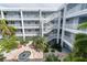 Open-air courtyard with a central fountain, garden areas, and staircase access at 2001 Bal Harbor Blvd # 2312, Punta Gorda, FL 33950
