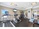 Well-equipped gym with treadmills, elliptical, weight machines, and wall-mounted TV at 2001 Bal Harbor Blvd # 2312, Punta Gorda, FL 33950