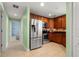 Kitchen with stainless steel appliances and adjacent hall with access to a bath at 2001 Bal Harbor Blvd # 2312, Punta Gorda, FL 33950