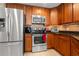 Kitchen with stainless steel appliances, granite countertops, and wooden cabinets at 2001 Bal Harbor Blvd # 2312, Punta Gorda, FL 33950