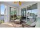 Relaxing lanai with wicker furniture, tiled floor and sliding glass doors overlooking the water at 2001 Bal Harbor Blvd # 2312, Punta Gorda, FL 33950