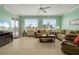 Living room featuring tile floors, a ceiling fan, and sliding glass doors to a balcony at 2001 Bal Harbor Blvd # 2312, Punta Gorda, FL 33950