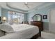 Main bedroom featuring a tray ceiling, balcony access, and a large dresser at 2001 Bal Harbor Blvd # 2312, Punta Gorda, FL 33950