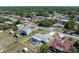 Aerial view showcasing a beautiful home with a screened pool, fenced-in yard, shed, and well-kept neighborhood at 21168 Quesada Ave, Port Charlotte, FL 33952