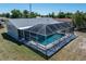 An aerial view of the backyard showcasing the screened-in pool and private outdoor space at 21168 Quesada Ave, Port Charlotte, FL 33952