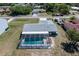 An aerial view showcases a private pool and screened-in lanai perfect for outdoor living and relaxation at 21168 Quesada Ave, Port Charlotte, FL 33952