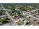 Full aerial perspective of a well-appointed home featuring a screened pool, secure fencing, and established community at 21168 Quesada Ave, Port Charlotte, FL 33952