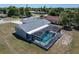Aerial view of a home showcasing a large screened-in pool and well-maintained backyard at 21168 Quesada Ave, Port Charlotte, FL 33952