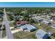 Aerial view showing a home with a screened-in pool, situated in a neighborhood with mature trees at 21168 Quesada Ave, Port Charlotte, FL 33952