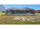 Wide backyard featuring a screened-in pool and ample room for outdoor activities and enjoyment at 21168 Quesada Ave, Port Charlotte, FL 33952