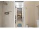 Bathroom shot focusing on tile shower and doorway to bedroom with neutral wall paint at 21168 Quesada Ave, Port Charlotte, FL 33952