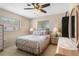 Bedroom with ceiling fan, two windows and traditional furnishings including lamps and dressers at 21168 Quesada Ave, Port Charlotte, FL 33952