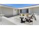 Covered front porch featuring pavers, furniture, a small table and landscaping at 21168 Quesada Ave, Port Charlotte, FL 33952