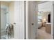Hallway view from bedroom to bathroom and shower with neutral wall paint at 21168 Quesada Ave, Port Charlotte, FL 33952