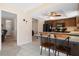 Bright kitchen features dark cabinets, black appliances, tile flooring, and a breakfast bar with seating at 21168 Quesada Ave, Port Charlotte, FL 33952